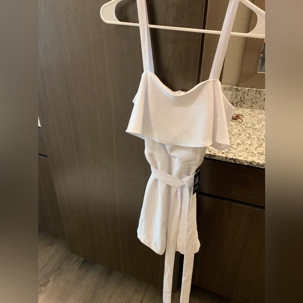 White Express short Romper. Zip up in back. Tie waist.